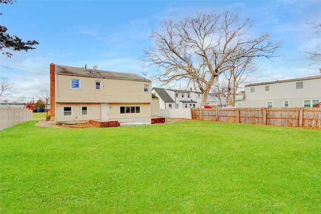 rear view of property with a lawn