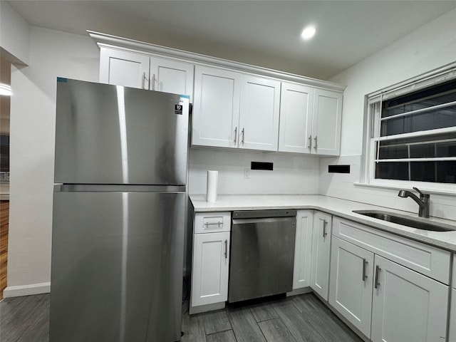 kitchen with sink, white cabinets, and appliances with stainless steel finishes