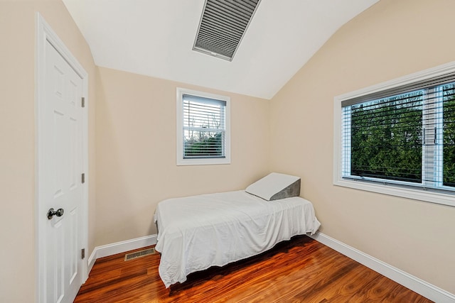 bedroom with hardwood / wood-style flooring and lofted ceiling