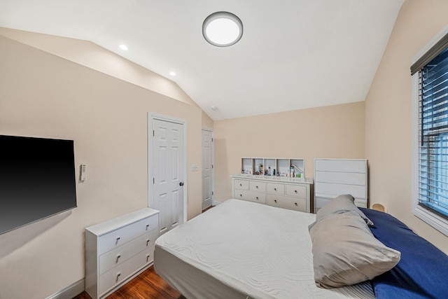 bedroom with wood-type flooring and vaulted ceiling