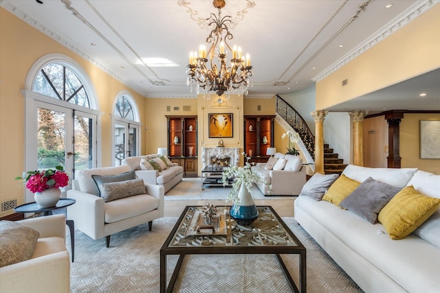 living room with ornate columns, french doors, an inviting chandelier, and ornamental molding