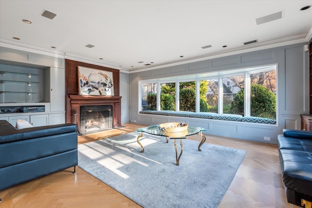 living room featuring crown molding and light parquet flooring