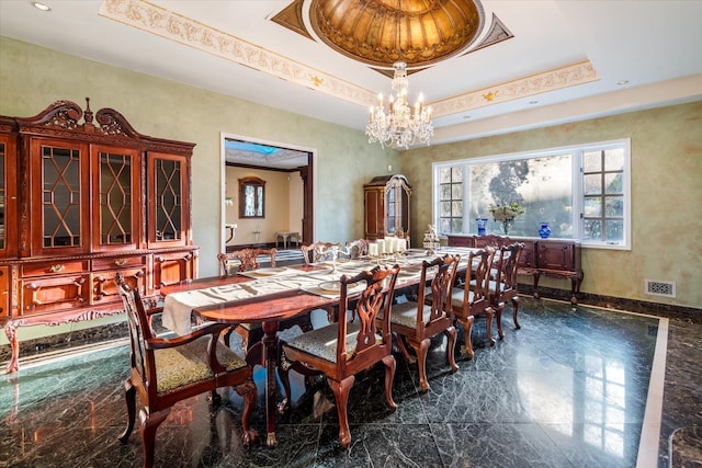 dining room featuring a raised ceiling and a notable chandelier