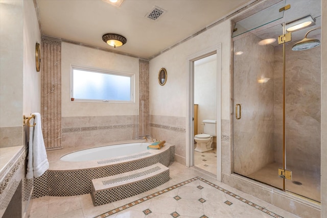 bathroom featuring separate shower and tub, tile patterned flooring, and toilet