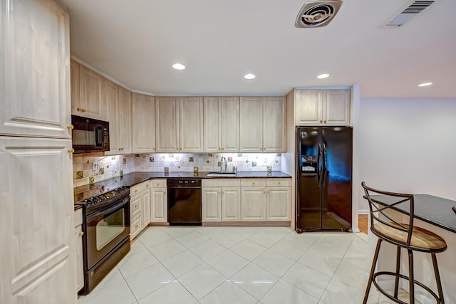 kitchen featuring black appliances, light tile patterned floors, sink, and tasteful backsplash