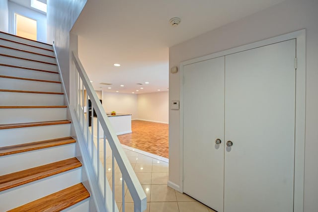 staircase featuring tile patterned flooring