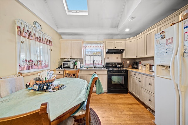 kitchen with sink, light hardwood / wood-style flooring, backsplash, white refrigerator with ice dispenser, and gas stove