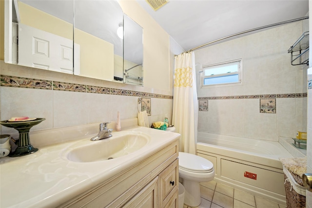 full bathroom featuring tile walls, vanity, tile patterned floors, toilet, and shower / bath combo with shower curtain