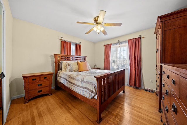 bedroom with ceiling fan and light hardwood / wood-style floors