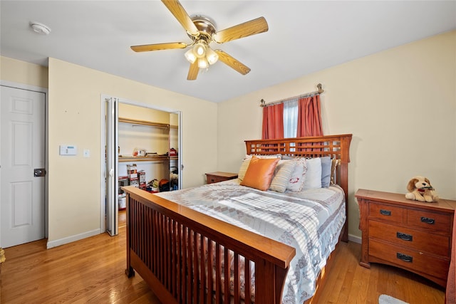 bedroom with a closet, ceiling fan, and light hardwood / wood-style flooring