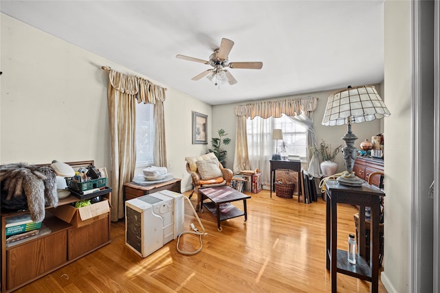 living area with hardwood / wood-style flooring and ceiling fan