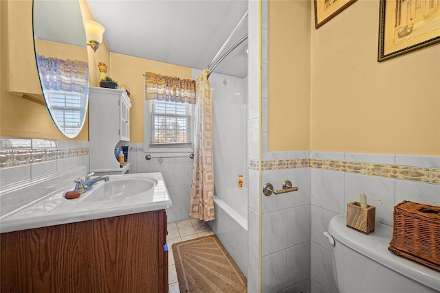 full bathroom with tile patterned floors, toilet, tile walls, vanity, and shower / bath combo with shower curtain