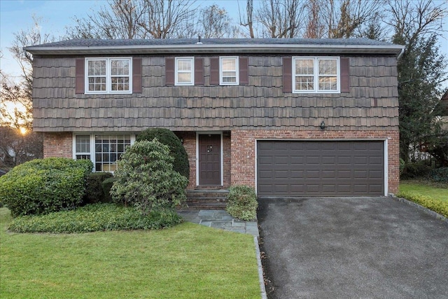 front of property featuring a garage and a yard