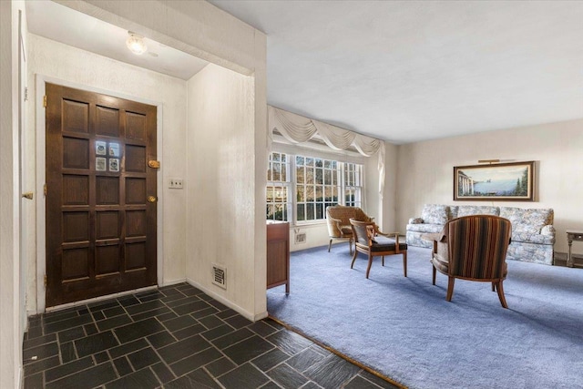 view of carpeted foyer