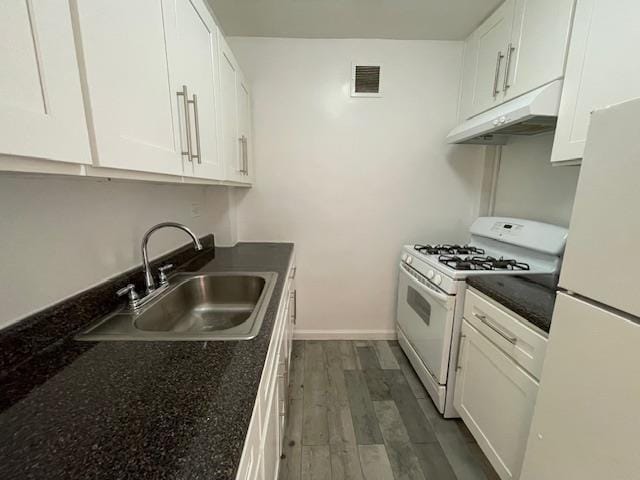 kitchen featuring white cabinetry, dark hardwood / wood-style flooring, sink, and white appliances