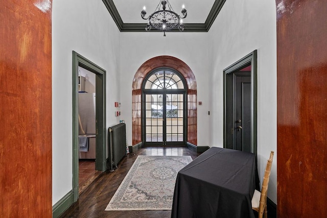 doorway to outside featuring arched walkways, french doors, crown molding, an inviting chandelier, and baseboards