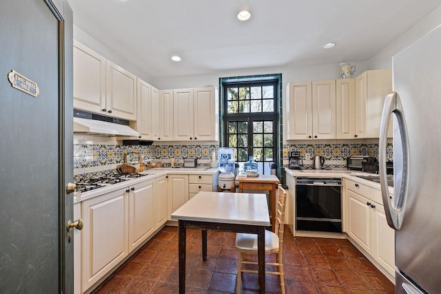 kitchen featuring black dishwasher, light countertops, freestanding refrigerator, and under cabinet range hood