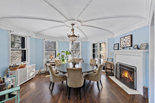 dining space featuring a wealth of natural light, a fireplace with flush hearth, dark wood finished floors, and crown molding