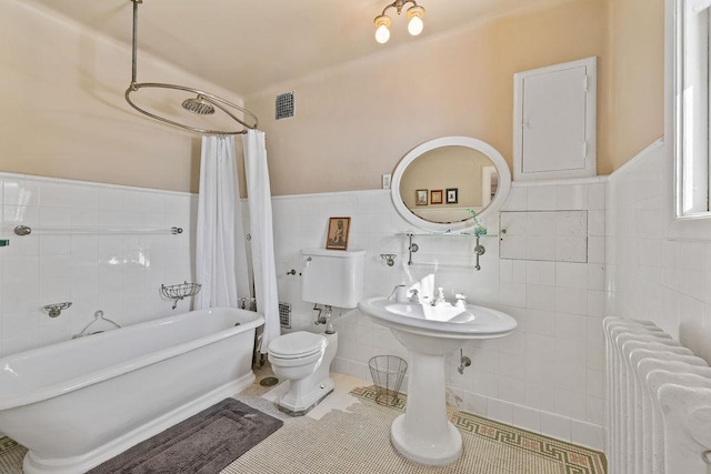 bathroom with visible vents, radiator, toilet, tile patterned floors, and shower / bath combination with curtain