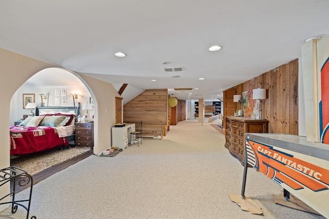 rec room with vaulted ceiling, wood walls, recessed lighting, and light colored carpet