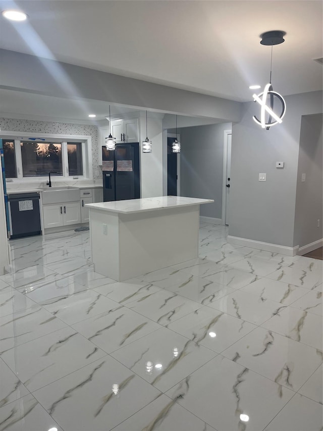 kitchen featuring black appliances, decorative light fixtures, white cabinetry, and sink