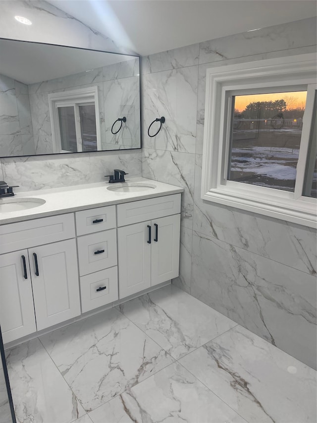 bathroom featuring vanity and tile walls