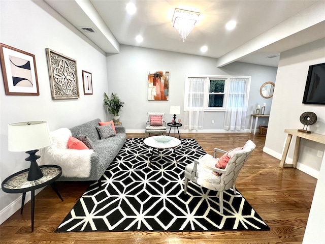 living area featuring recessed lighting, wood finished floors, visible vents, and baseboards