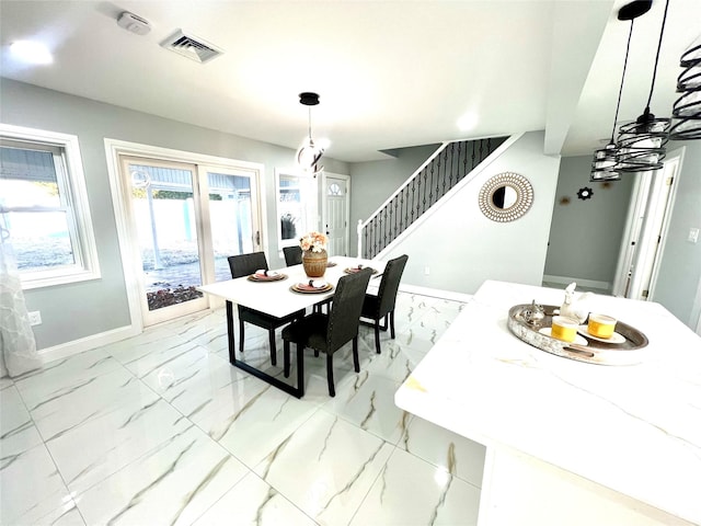 dining area featuring marble finish floor, stairway, visible vents, and baseboards