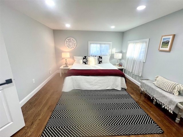 bedroom with dark wood-style floors, baseboards, and recessed lighting