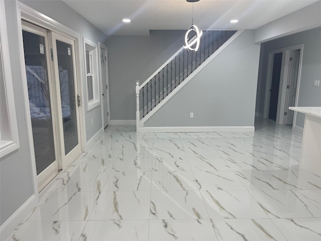 unfurnished room featuring marble finish floor, baseboards, stairway, and recessed lighting