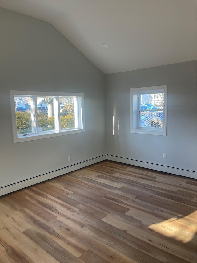 empty room with lofted ceiling and wood finished floors