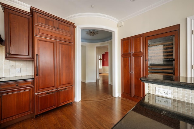 kitchen featuring backsplash, dark hardwood / wood-style floors, and ornamental molding