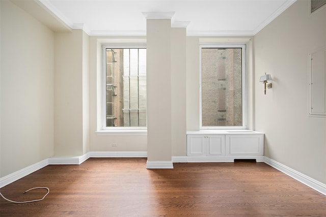 unfurnished room featuring dark wood-type flooring and ornamental molding