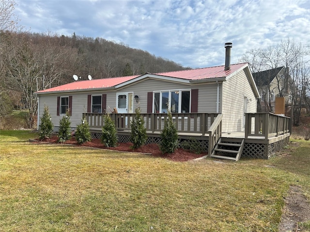 view of front of home featuring a front yard and a deck