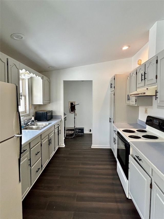 kitchen featuring sink, white cabinets, dark wood-type flooring, and white appliances