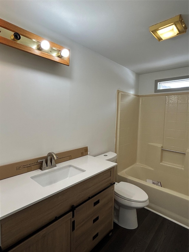 full bathroom featuring hardwood / wood-style flooring, vanity, toilet, and shower / washtub combination