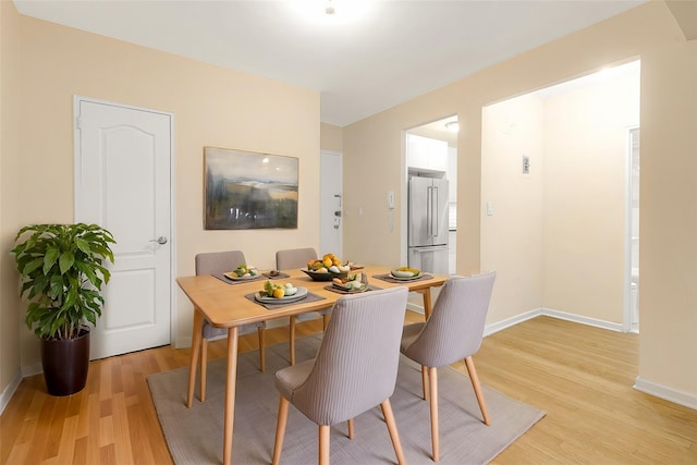 dining space featuring light wood-type flooring