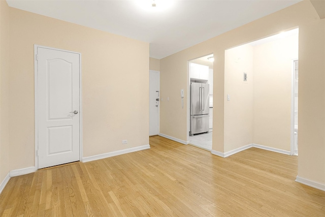 spare room with light hardwood / wood-style flooring