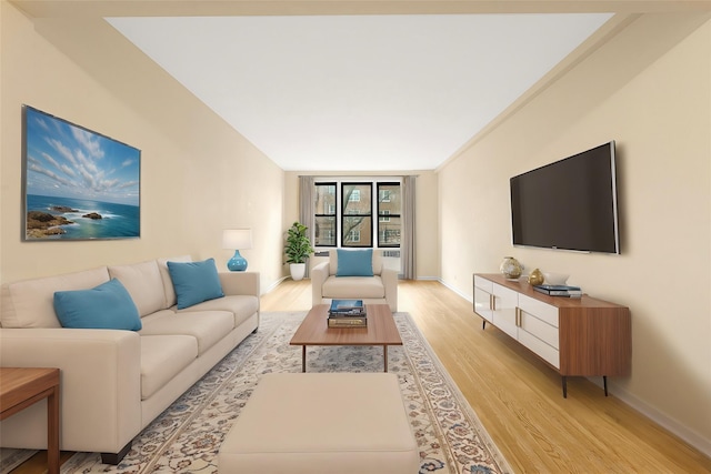 living room with light hardwood / wood-style flooring and a wall of windows