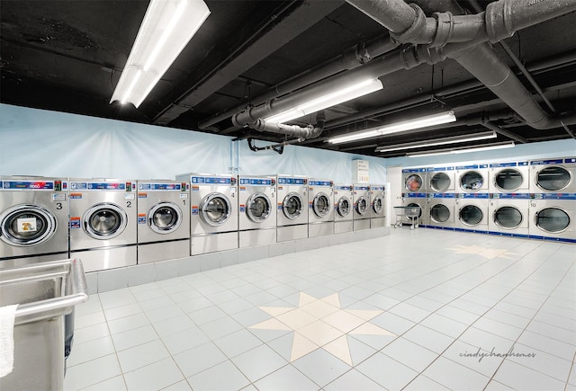 washroom featuring washer and dryer, tile patterned floors, and stacked washer / dryer