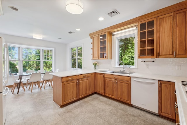 109 Argyll Ave, New Rochelle, NY 10804 - kitchen featuring white appliances, a peninsula, brown cabinetry, and recessed lighting
