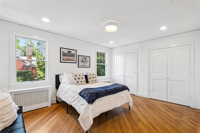 109 Argyll Ave, New Rochelle, NY 10804 - bedroom featuring radiator heating unit, multiple closets, light wood-type flooring, and recessed lighting