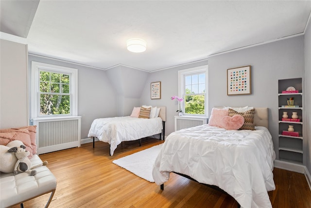 109 Argyll Ave, New Rochelle, NY 10804 - bedroom featuring radiator heating unit, light wood-style floors, and multiple windows