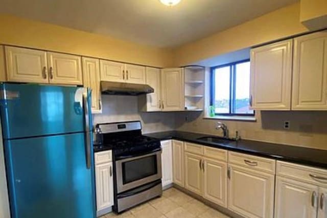 kitchen with white cabinetry, sink, black fridge, electric stove, and light tile patterned floors