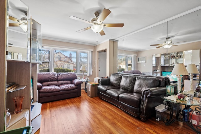 living room with a healthy amount of sunlight, crown molding, and hardwood / wood-style floors