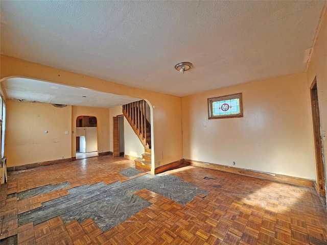 129-06 131st St, South Ozone Park, NY 11420 - spare room featuring arched walkways, stairs, and a textured ceiling