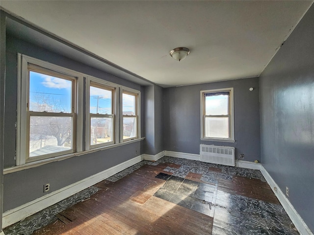 129-06 131st St, South Ozone Park, NY 11420 - unfurnished room featuring radiator heating unit and baseboards