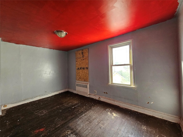 129-06 131st St, South Ozone Park, NY 11420 - empty room featuring radiator heating unit and wood-type flooring