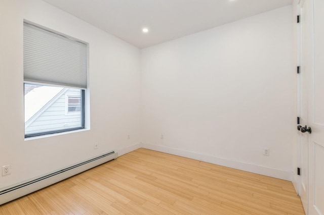 spare room with light hardwood / wood-style floors and a baseboard radiator