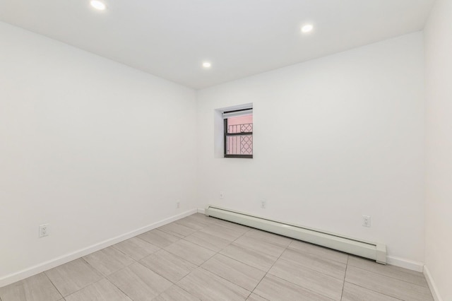 unfurnished room featuring baseboard heating